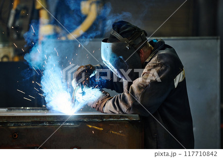 Performing Metal Welding in Industrial Environment Performing Metal Welding in Industrial Environment 117710842