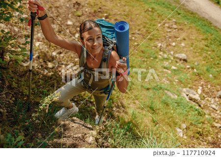 An Adventurous Hiker Climbing and Scaling a Rugged Rocky Trail in the Great Outdoors 117710924
