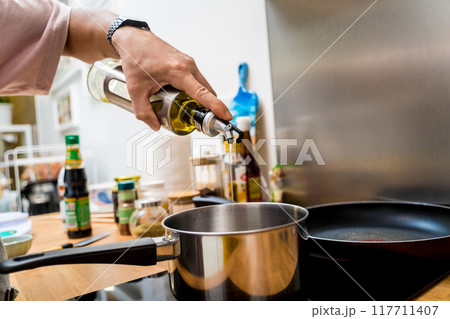Chef at the kitchen preparing pumpkin porridge with tofu and vegetables 117711407