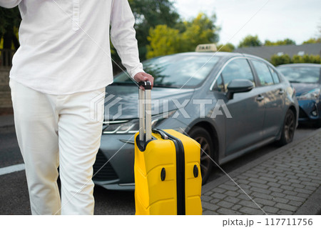 Catching a Cab. Male traveller standing near airport, waving hand, calling taxi driver, free space 117711756