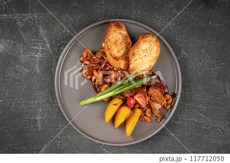Portion of sweet and sour pork meat with potato Portion of sweet and sour pork meat with potato 117712050