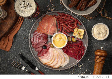 Portion of meat appetizer platter with beer 117712051