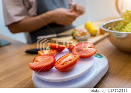Chef at the kitchen preparing spicy glass noodle salad 117712332
