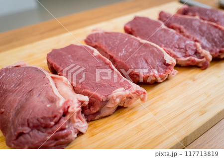 Raw fillet beef meat for steaks on the cutting board 117713819
