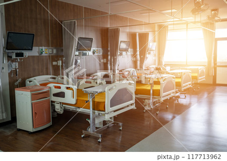 A hospital room with a bed and a television A hospital room with a bed and a television 117713962