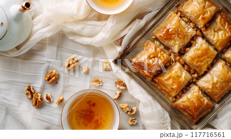 Traditional Baklava with Walnuts and Tea on White Fabric 117716561