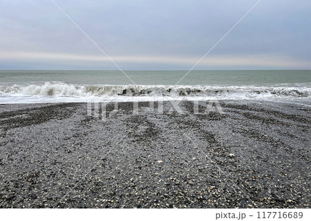 Black sand and stones, sky cloud and ocean wave Black sand and stones, sky cloud and ocean wave 117716689