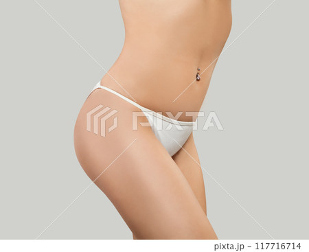 Front view of a pretty woman's hips in white panties on white background Front view of a pretty woman's hips in white panties on white background 117716714