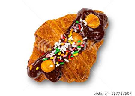 Croissant garnished with chocolate and rainbow sprinkles. 117717507