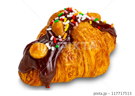 Croissant garnished with chocolate and rainbow sprinkles. 117717513