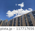 High rise building with blue sky and white clouds, closeup of photo	 117717656