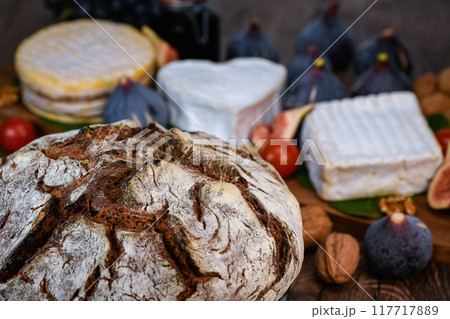 Selection of French cheeses from Normandy, AOP, Livarot, Neufchatel, Pont l'eveque, Rye bread, figs 117717889