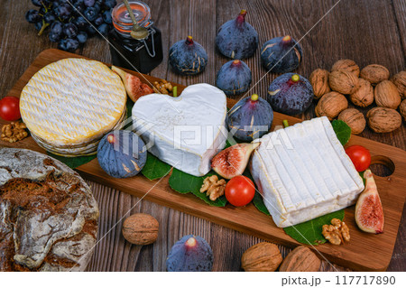 Selection of French cheeses from Normandy, AOP, Livarot, Neufchatel, Pont l'eveque, Rye bread, figs 117717890