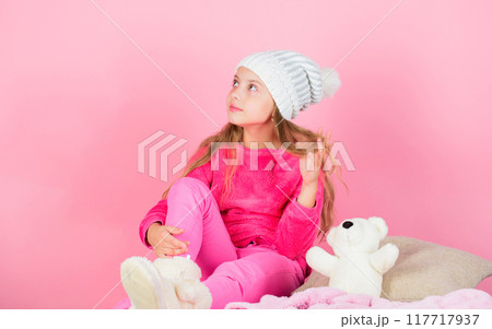 Child small girl playful hold teddy bear plush toy. Kid cute girl play with soft toy teddy bear pink background. Unique attachments to stuffed animals. Teddy bears improve psychological wellbeing 117717937