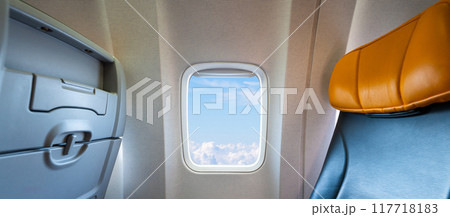Stunning view from airplane window seat above clouds in flight. Concept of travel and sky Stunning view from airplane window seat above clouds in flight. Concept of travel and sky 117718183