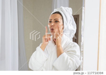 Young woman doing facial gymnastics self massage and rejuvenating exercises. Face building for skin and muscles lifting Young woman doing facial gymnastics self massage and rejuvenating exercises. Face building for skin and muscles lifting 117718394