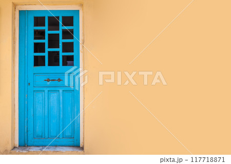 Yellow wall background with blue retro door 117718871
