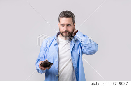 concerned moneyless man with wallet in studio. moneyless man with wallet at hand. concerned moneyless man with wallet in studio. moneyless man with wallet at hand. 117719027