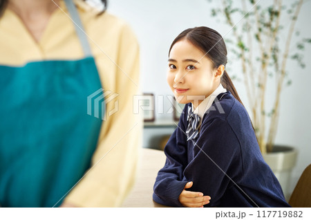 エプロン姿の母親と制服を着た娘 エプロン姿の母親と制服を着た娘 117719882