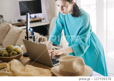 Content creator preparing to record video with ring light and laptop, digital media production, influencer workspace, online content creation, social media strategy. Content creator preparing to record video with ring light and laptop, digital media production, influencer workspace, online content creation, social media strategy. 117720178