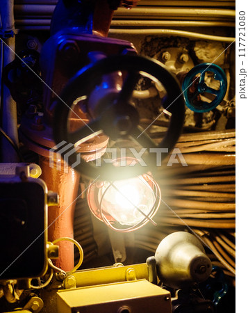 blue valve and lamp in old submarine close up 117721080
