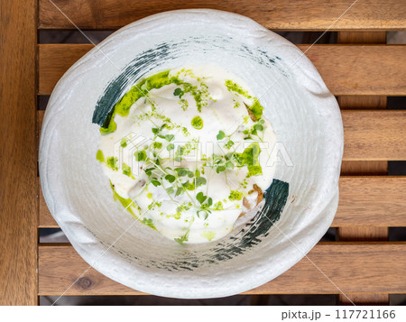 bechamel and pesto sauce in bowl on wooden table 117721166