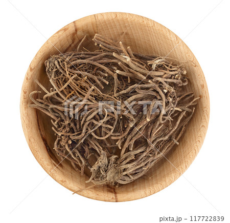 Dried Valerian root in wooden bowl isolated on white background. Valeriana officinalis with full depth of field. Top view. Flat lay Dried Valerian root in wooden bowl isolated on white background. Valeriana officinalis with full depth of field. Top view. Flat lay 117722839
