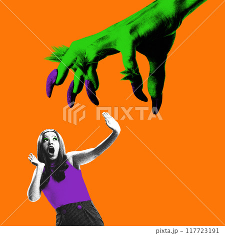 Terrified woman screaming as giant green monster hand with purple claws reaching down towards her, against orange background. Moment of horror. Contemporary art collage. 117723191