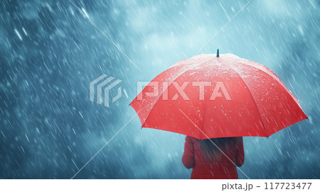 Person holding a red umbrella in heavy rain, rear view, wearing a red coat 117723477