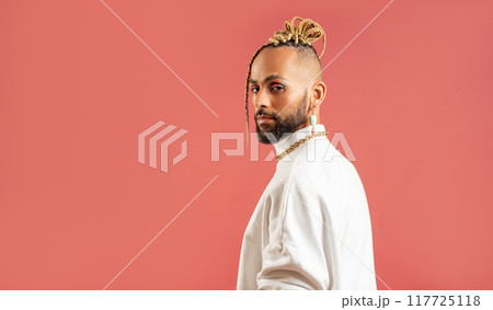 Black latin gay man isolated on pink background Black latin gay man isolated on pink background 117725118