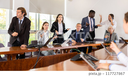 Irritated boss scolding associates, pointing out shortcomings and misses in work Irritated boss scolding associates, pointing out shortcomings and misses in work 117727867
