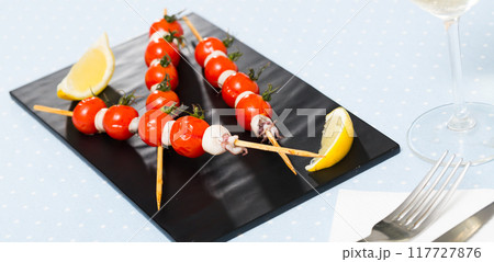 Skewers with mini calamari and tomatoes Skewers with mini calamari and tomatoes 117727876