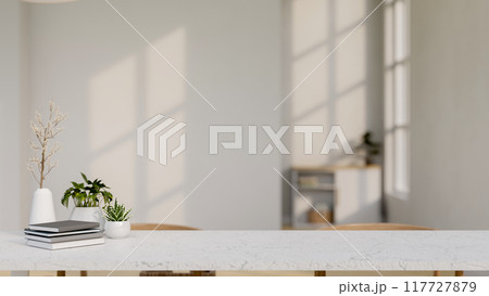 A copy space for displaying products on a white tabletop in a white room. A copy space for displaying products on a white tabletop in a white room. 117727879