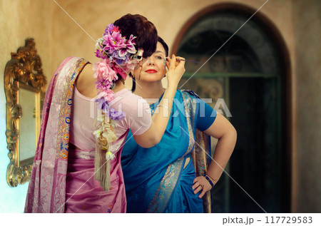Capturing Camaraderie: Dancers in Vibrant Saris Perfect Their Look Together Before Cultural Celebration. Capturing Camaraderie: Dancers in Vibrant Saris Perfect Their Look Together Before Cultural Celebration. 117729583