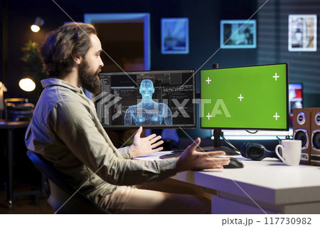 Software developer unable to believe eyes after seeing AI gaining humanoid form on green screen monitor. Computer scientist surprised by artificial intelligence materializing on chroma key display 117730982