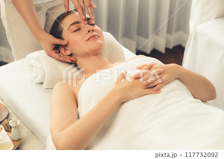 Caucasian woman enjoying relaxing anti-stress head massage. Quiescent Caucasian woman enjoying relaxing anti-stress head massage. Quiescent 117732092