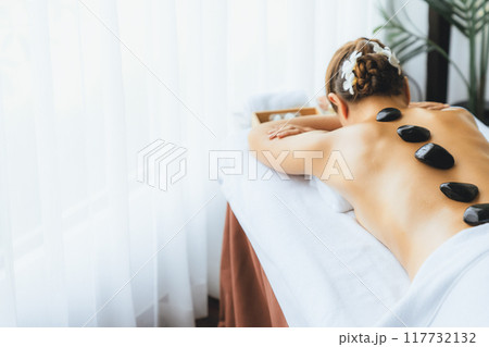 Hot stone massage at spa salon in luxury resort. Quiescent 117732132