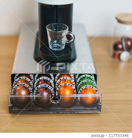 Espresso Coffee Maker Machine with Capsule of roasted coffee bean on wood table bar. Daily beverage drink at Home, Apartment and Office concept 117733348