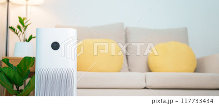 Air Purifier in cozy living room. Purification system for filter and cleaning or removing dust PM2.5 HEPA and virus in home. Allergy, Pure air, health lifestyle, Wellness life and Air Pollution 117733434