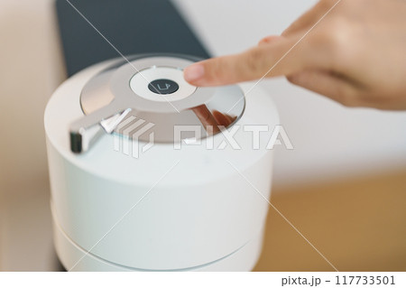 hand making Espresso Coffee by Coffee Maker Machine on wood table bar. Daily beverage drink at Home, Apartment and Office concept 117733501