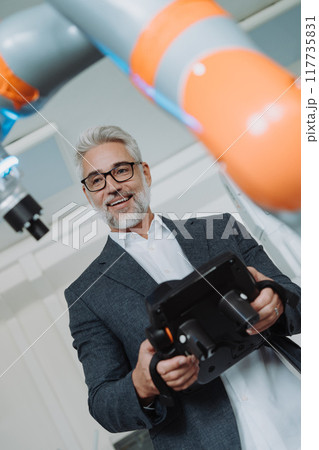 Automation, robotics engineer working on robotic knee replacement surgery project. Concept of modern technology in medicine, automated processes, healthcare. Automation, robotics engineer working on robotic knee replacement surgery project. Concept of modern technology in medicine, automated processes, healthcare. 117735831