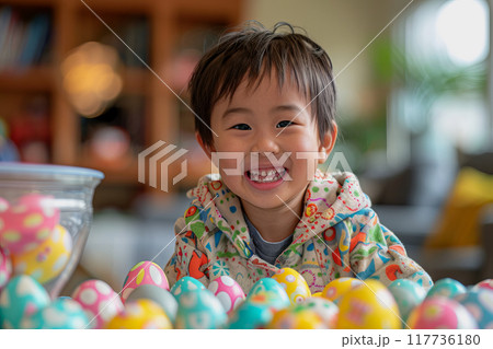 A young child is creatively adorning Easter eggs with vibrant colors.. 117736180