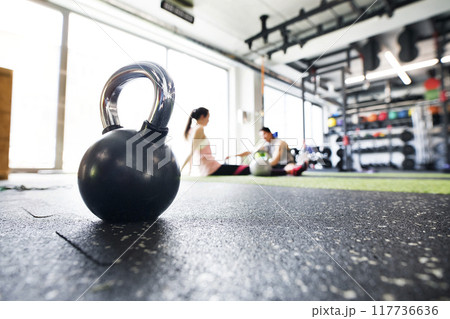 Kettlebells on floor in gym. Gym equipment for strength training. 117736636