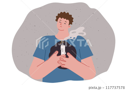 Man lost hope and grieving, feeling devastation, holding extinguished candle in front of chest 117737578