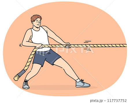 Strong man pulls rope while participating in sports competitions or training in fitness club 117737752