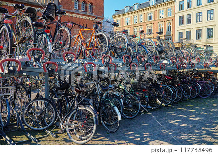 Many bicycles parked at a public bike rack in Copenhagen Many bicycles parked at a public bike rack in Copenhagen 117738496