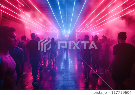 People walking through neon-lit corridor with smoke effect and reflective floor creating vibrant atmosphere in night setting 117739604