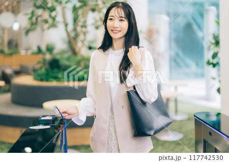 セキュリティゲートを通って退勤する女性 セキュリティゲートを通って退勤する女性 117742530