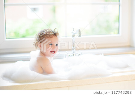 Baby taking bath in kitchen sink Baby taking bath in kitchen sink 117743298