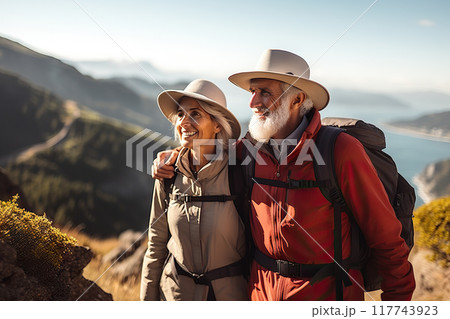 Awe-Inspiring Retirement Senior Couple Marvels at Pacific Coast Beauty, Embracing Nature's Wonders on a Mountain Hiking Adventure. created with Generative AI 117743923